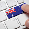 Computer key with the Australia on it. Male hand pressing computer key with Australia flag.