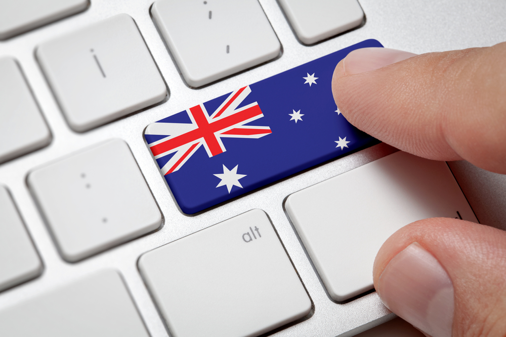 Computer key with the Australia on it. Male hand pressing computer key with Australia flag.